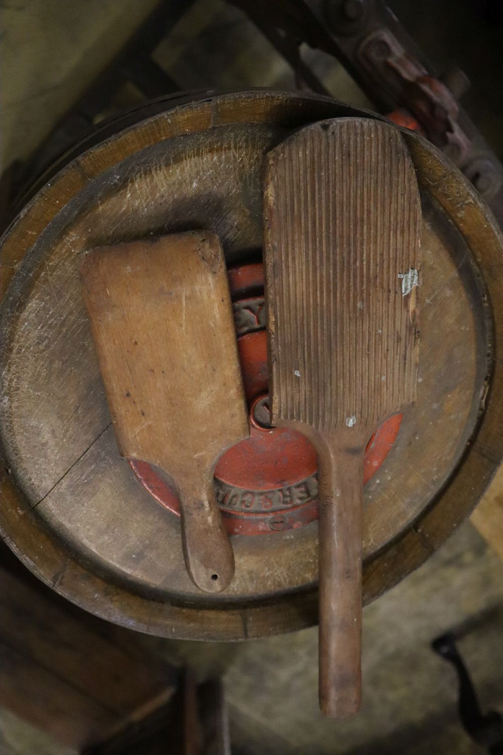 An early 20th century butter churn and two butter pats, width 64cm height 103cm